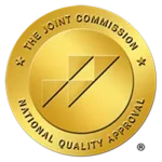 Gold circular seal reading 'The Joint Commission National Quality Approval' symbolizing quality accreditation by The Joint Commission.