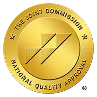 Gold circular seal reading 'The Joint Commission National Quality Approval' symbolizing quality accreditation by The Joint Commission.